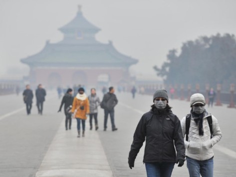 Tourists wear facial masks while visiting the Temple of Heaven Park in Beijing in January. (Photo: Li Wen/Xinhua/Landov)